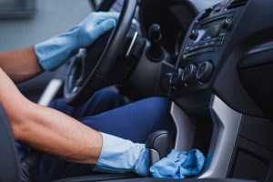 hands cleaning a car